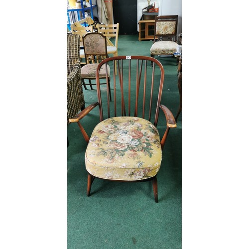 543 - Ercol arm chair spindle back in dark elm.