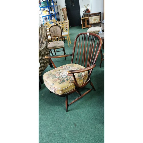 543 - Ercol arm chair spindle back in dark elm.