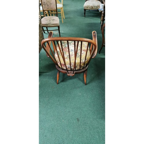 543 - Ercol arm chair spindle back in dark elm.