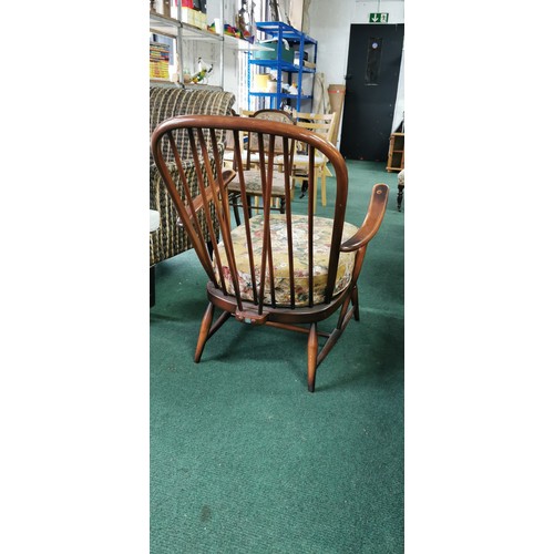 543 - Ercol arm chair spindle back in dark elm.