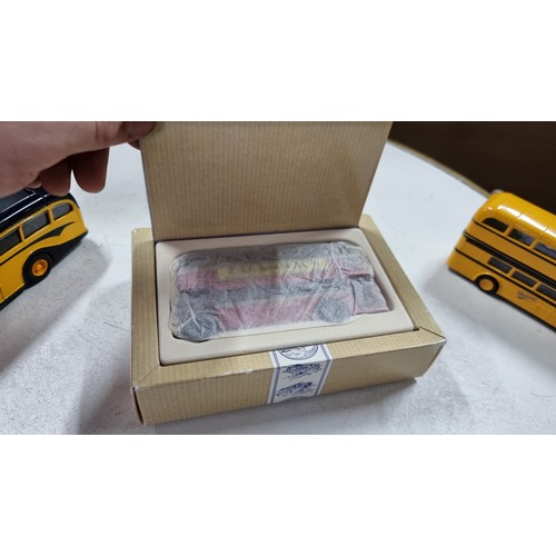 12 - 3x boxed as new diecast busses 2x by corgi along with 2x unboxed corgi yellow busses in excellent co... 