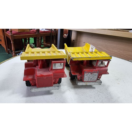 13 - Pair of large Dinky toy centaur diecast dump trucks in good condition height 9cm length 18cm