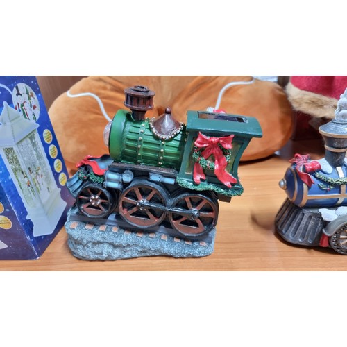 16 - Quantity of christmas ornaments inc a solar powered sants loco with light a battery powered two piec... 