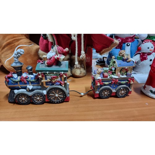 16 - Quantity of christmas ornaments inc a solar powered sants loco with light a battery powered two piec... 