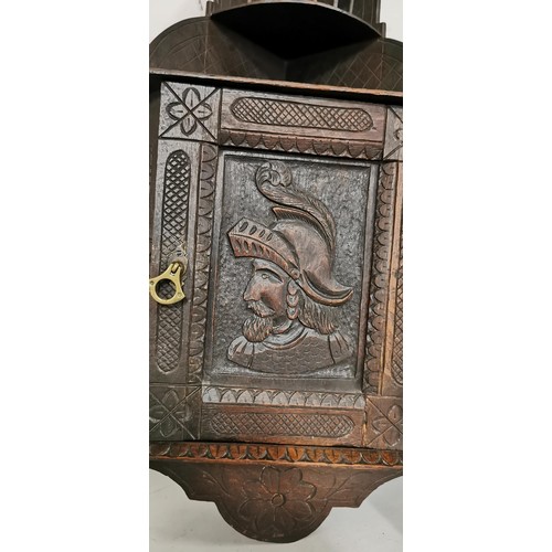 105 - Vintage ornate carved oak corner cupboard with a portrait carving on the door, galleried shelf to th... 