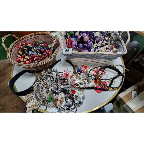 66 - 2x baskets containing a large quantity of various costume jewellery