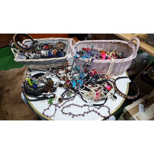 67 - 2x baskets containing a large quantity of various costume jewellery