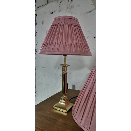 175 - 2x modern brass table lamps with pink shades & a spare pink shade. Measures 45cm height.