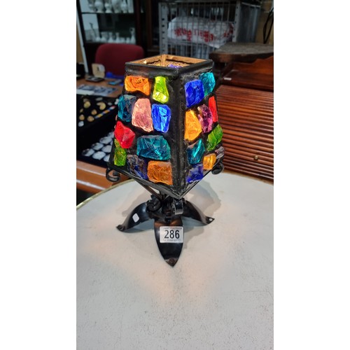 286 - Unusual iron table lamp with multi coloured glass faceted rock shade displays well when lit up  in g... 