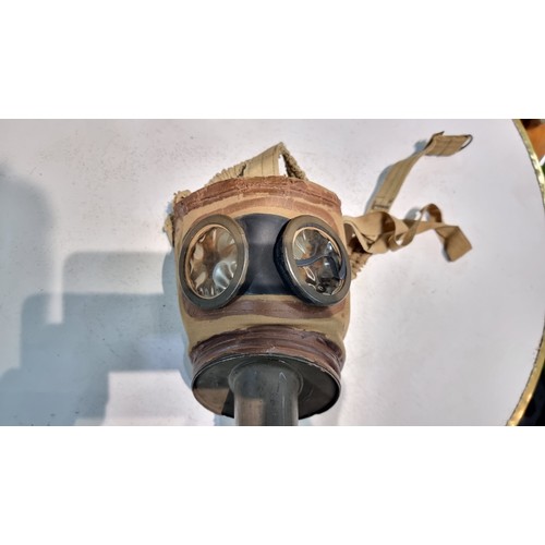 287 - Rare vintage German gas mask fitted in its original metal tin with various markings to the mask