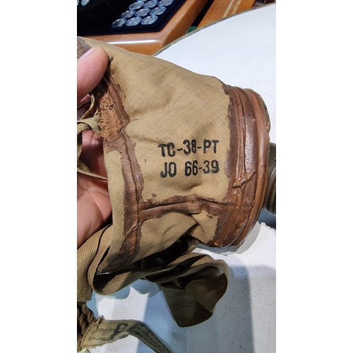 287 - Rare vintage German gas mask fitted in its original metal tin with various markings to the mask