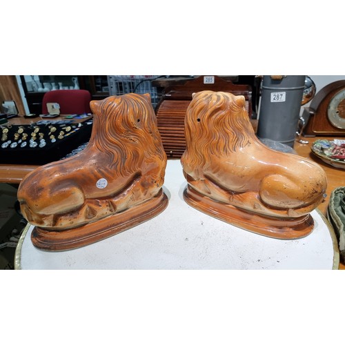 296 - Pair of antique staffordshire style Scottish Bo'ness pottery recumbent lions with painted features a... 