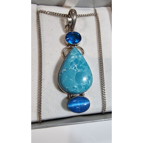 309 - Large ornate 925 silver pendant inset with a turquoise stone and 2x blue stones set on a good 16in 9... 