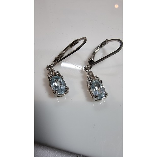 324 - Pair of pretty 925 silver clip back earrings inset with genuine blue topaz stones boxed in clean con... 