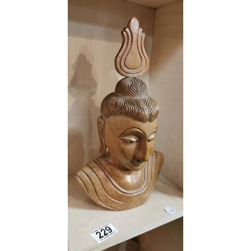 229 - Intricately carved wooden Buddha bust figure in very good condition made from a hardwood. 32.5cm hei... 