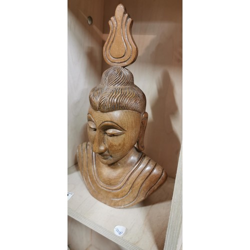 229 - Intricately carved wooden Buddha bust figure in very good condition made from a hardwood. 32.5cm hei... 