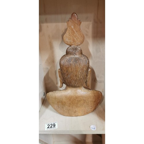 229 - Intricately carved wooden Buddha bust figure in very good condition made from a hardwood. 32.5cm hei... 