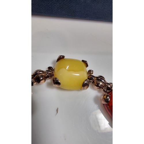 342 - 925 silver bracelet inset with tri coloured natural amber stones inc orange amber, green amber and y... 