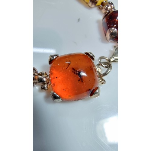 342 - 925 silver bracelet inset with tri coloured natural amber stones inc orange amber, green amber and y... 