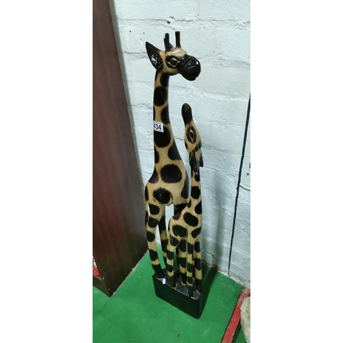 434 - Well-made hand carved wooden mother giraffe with her calf. Repair to the neck on one of the giraffes... 