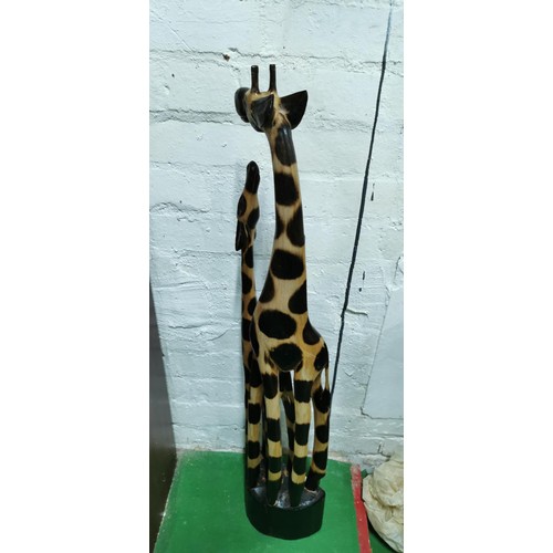 434 - Well-made hand carved wooden mother giraffe with her calf. Repair to the neck on one of the giraffes... 