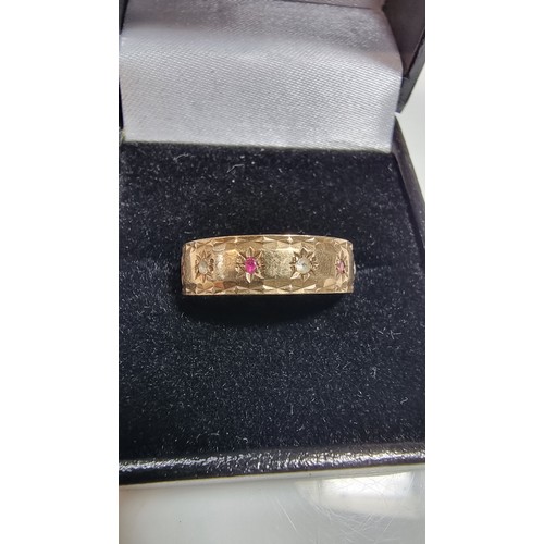 370 - Hallmarked yellow gold eternity ring inset with ruby stones and white topaz stones all the way round... 