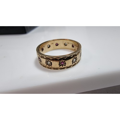 370 - Hallmarked yellow gold eternity ring inset with ruby stones and white topaz stones all the way round... 