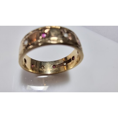 370 - Hallmarked yellow gold eternity ring inset with ruby stones and white topaz stones all the way round... 