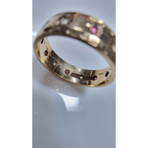 370 - Hallmarked yellow gold eternity ring inset with ruby stones and white topaz stones all the way round... 