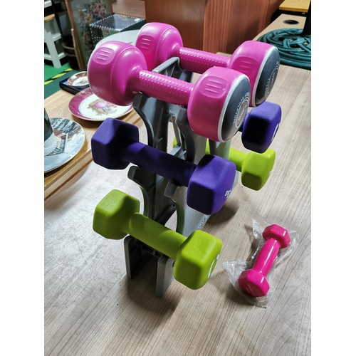 140 - Set of weight training dumbells on stand 1.5kg, 3kg, 4kg weights. In very good condition.