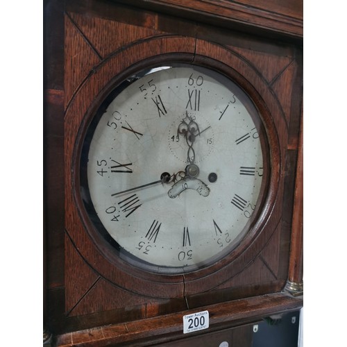 200 - Large oak antique long case striking grandfather clock complete with weights. has a cupboard to the ... 