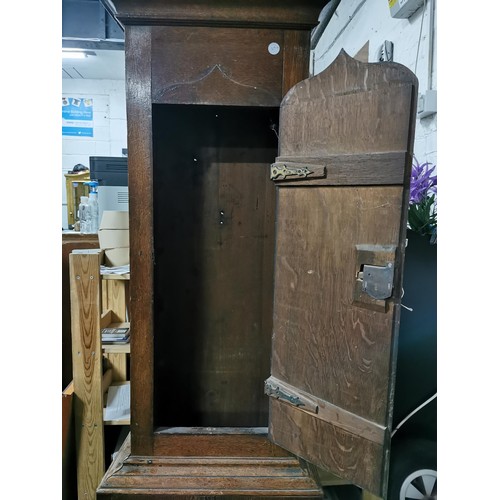 200 - Large oak antique long case striking grandfather clock complete with weights. has a cupboard to the ... 