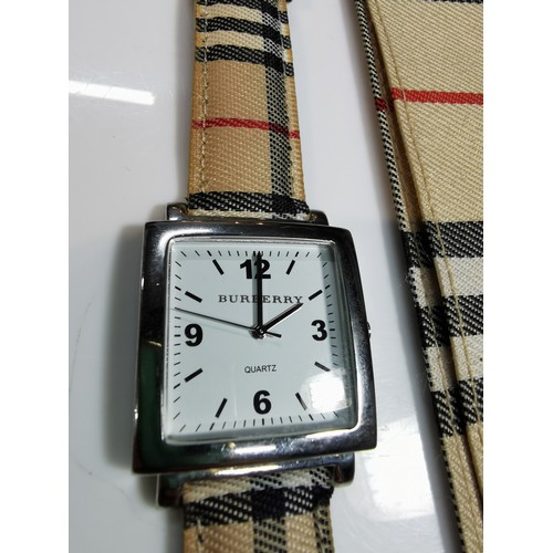 318 - Unused unisex burberry quartz watch with a chrome bezel in its original taran case with tartan strap... 