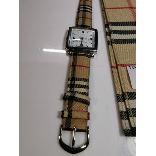 318 - Unused unisex burberry quartz watch with a chrome bezel in its original taran case with tartan strap... 