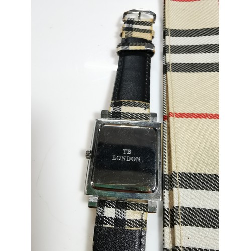 318 - Unused unisex burberry quartz watch with a chrome bezel in its original taran case with tartan strap... 