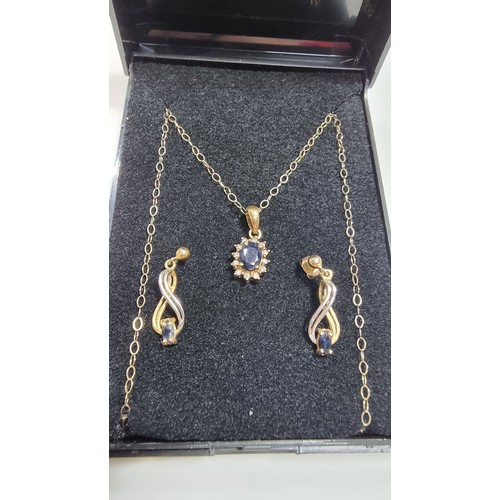 382 - 9ct yellow gold pendant and 16in chain and matching earrings, pendant is inset with dark blue sapphi... 