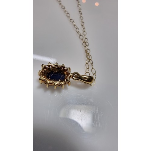 382 - 9ct yellow gold pendant and 16in chain and matching earrings, pendant is inset with dark blue sapphi... 