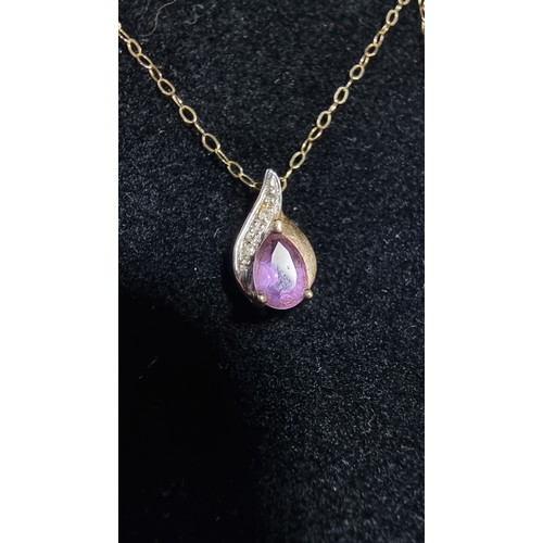 383 - 9ct yellow gold pendant on a 16in chain pendant is inset with an amethyst gemstone and two small dia... 