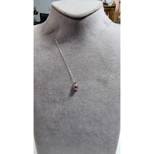 383 - 9ct yellow gold pendant on a 16in chain pendant is inset with an amethyst gemstone and two small dia... 