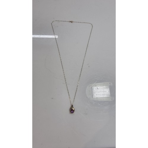 383 - 9ct yellow gold pendant on a 16in chain pendant is inset with an amethyst gemstone and two small dia... 