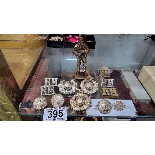 395 - Quantity of Royal Marines badges and buttons along with a small bronze figure of a soldier height of... 