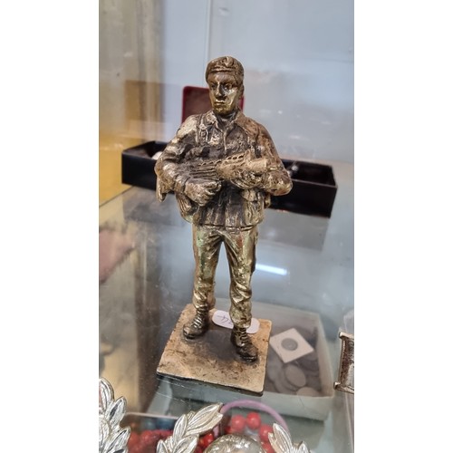 395 - Quantity of Royal Marines badges and buttons along with a small bronze figure of a soldier height of... 