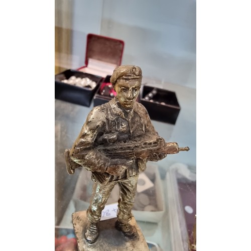 395 - Quantity of Royal Marines badges and buttons along with a small bronze figure of a soldier height of... 