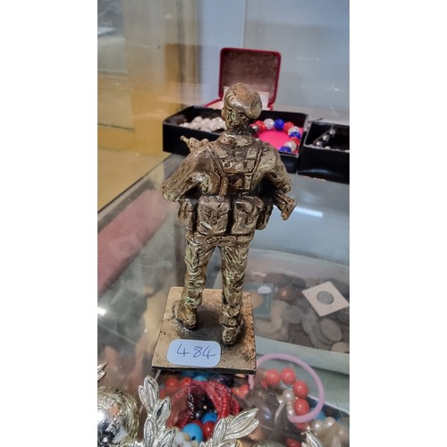 395 - Quantity of Royal Marines badges and buttons along with a small bronze figure of a soldier height of... 