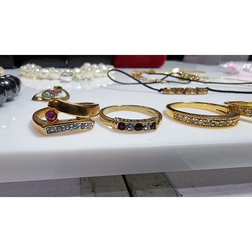 399 - Quantity of costume jewellery inc 5 gold-plated dress rings one inset with a real ruby stone