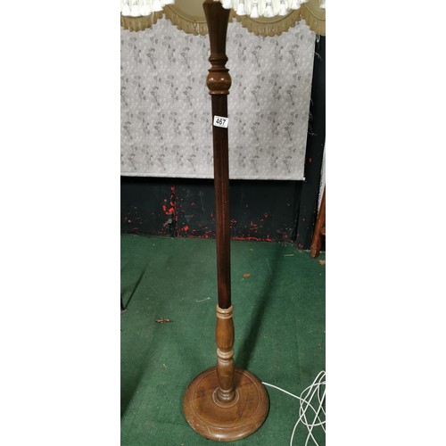 467 - Mid Century oak floor standing lamp with white tasseled shade in good overall condition. Height inc ... 