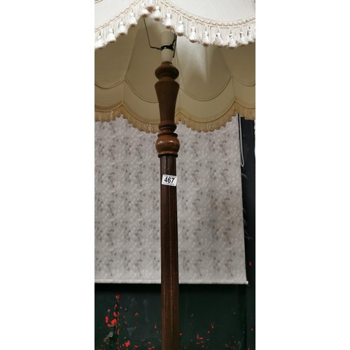 467 - Mid Century oak floor standing lamp with white tasseled shade in good overall condition. Height inc ... 