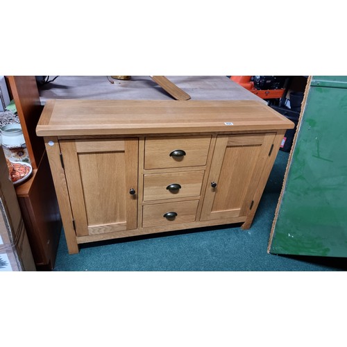 496 - Modern solid light oak sideboard with two doors and three drawers in excellent clean condition throu... 