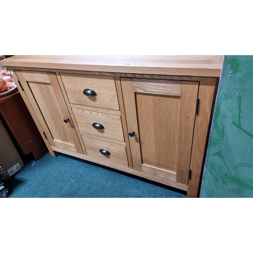 496 - Modern solid light oak sideboard with two doors and three drawers in excellent clean condition throu... 