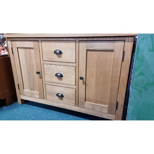 496 - Modern solid light oak sideboard with two doors and three drawers in excellent clean condition throu... 